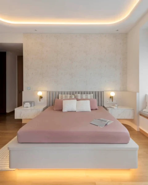 HDB master bedroom with platform bed, feature wall and layered cove lighting by Lemonfridge Studio