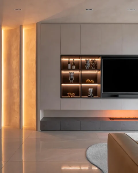 Premium living room with feature wall, warm light, and built-in storage design ideas