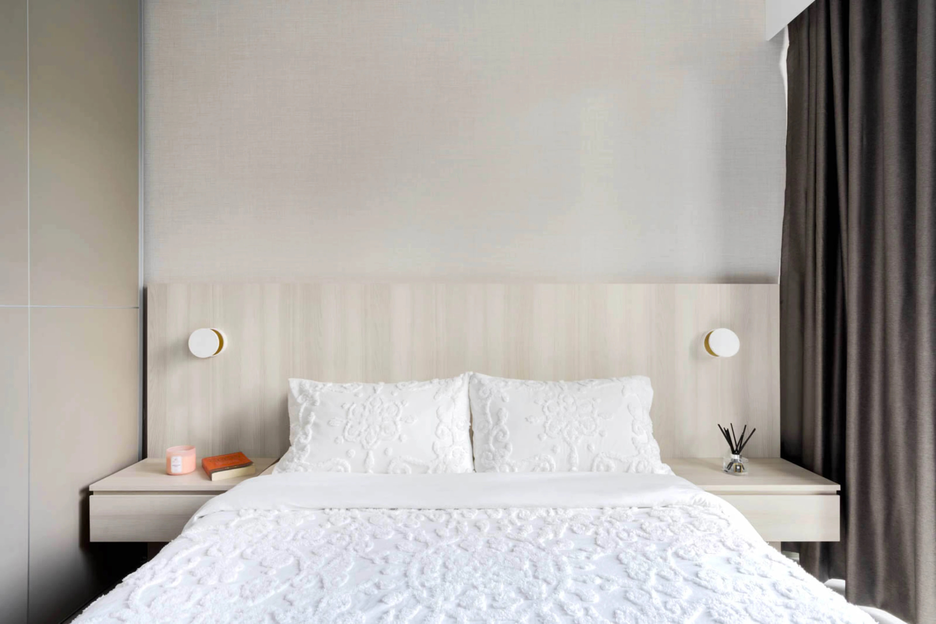 Minimalist HDB master bedroom with white platform bed, built-in headboard and soft natural light
