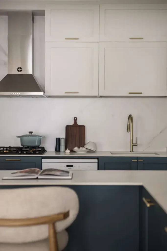 Modern kitchen with glass and marble backsplash behind stove and sink