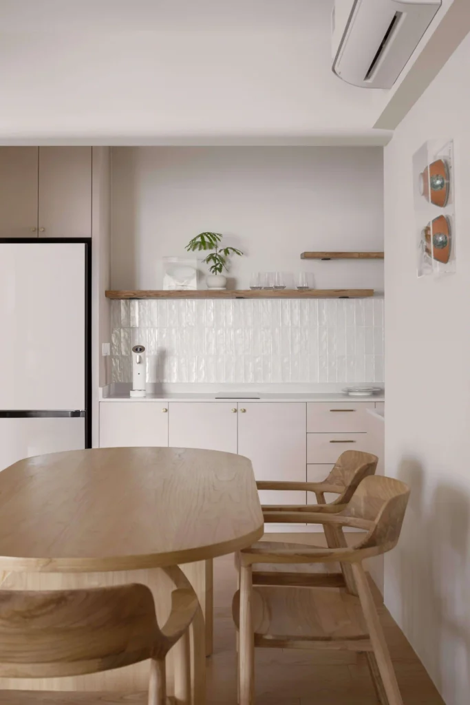 Light-timber BTO kitchen with white vertical-tile backsplash, oak dining set and open wood shelves