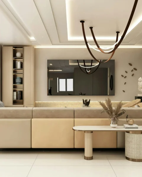 Modern living room with recessed cove lights and sculptural pendants, demonstrating scene-based smart mood lighting