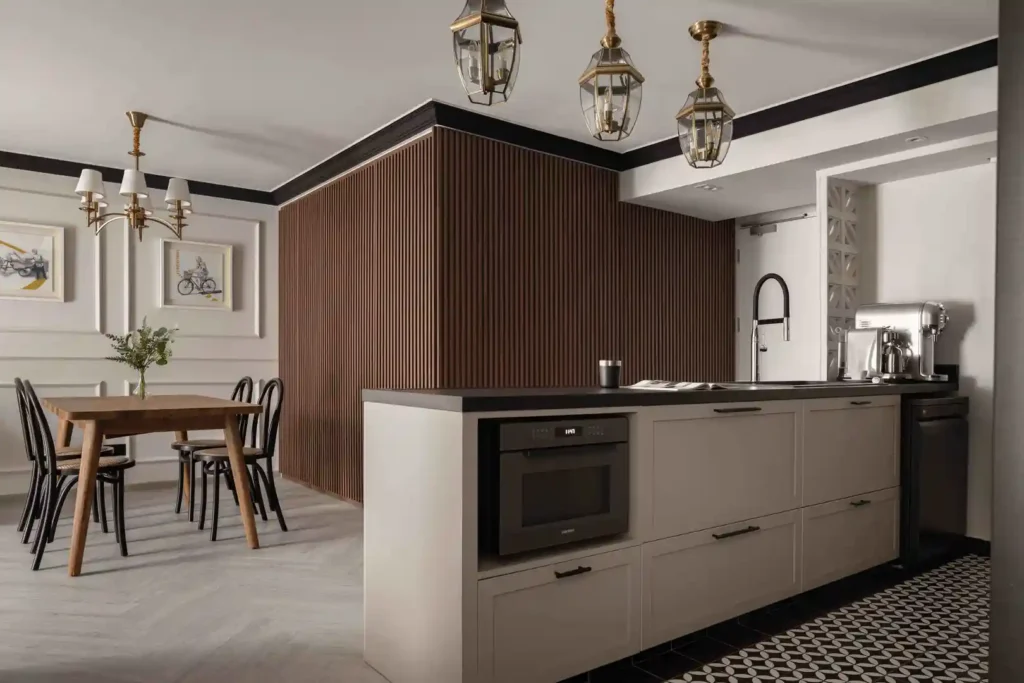 Modern-colonial kitchen with fluted wood feature, shaker cabinets and brass lantern pendants