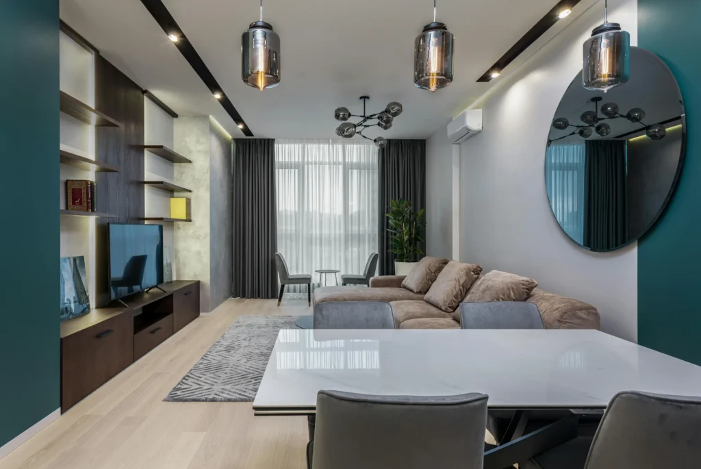 Open-plan living room showing smart dimmers and accent lighting around TV shelving, ideal for automated scenes and reliable mesh Wi-Fi coverage.