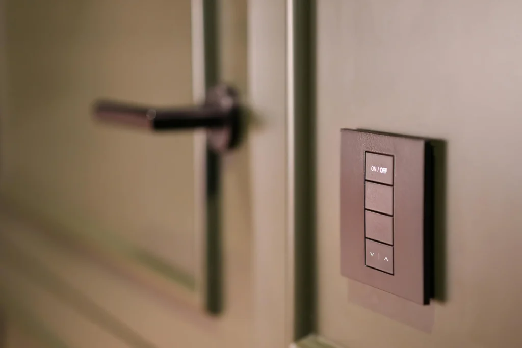 Close-up of a smart dimmer switch on a paneled wall—example of always-powered lighting with neutral wire for reliable app and automation control.