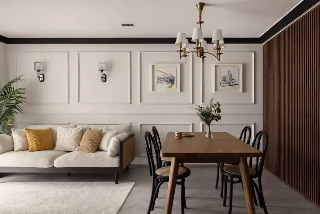 Modern classic dining area with wall panelling, brass chandelier, timber dining table, and a neutral sofa.