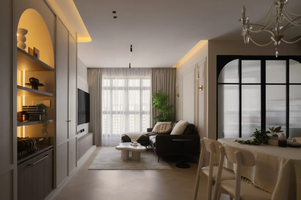 Living-dining space with an arched display niche, built-in shelving, and a black-framed glass partition.