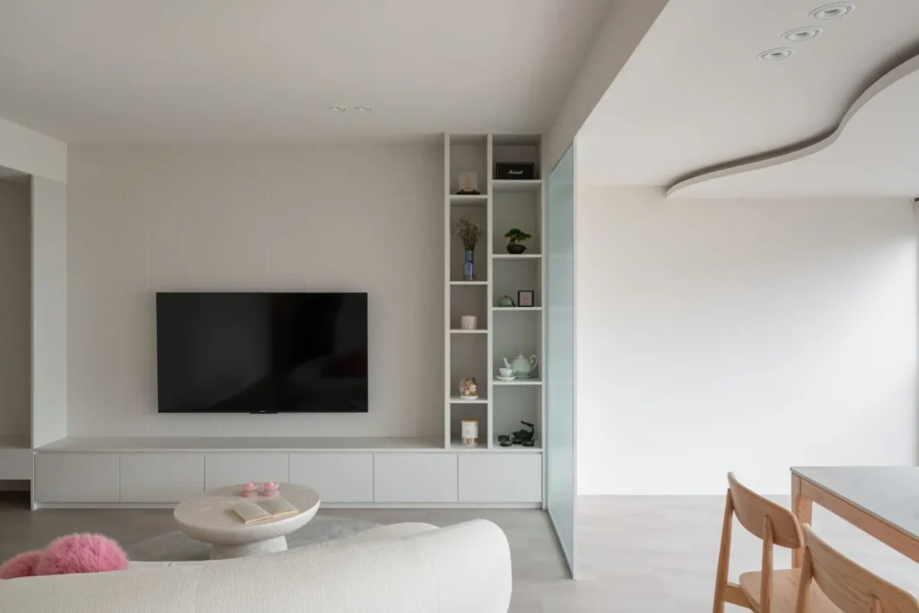 Close-up view of a TV feature wall with cabinetry and panel details.